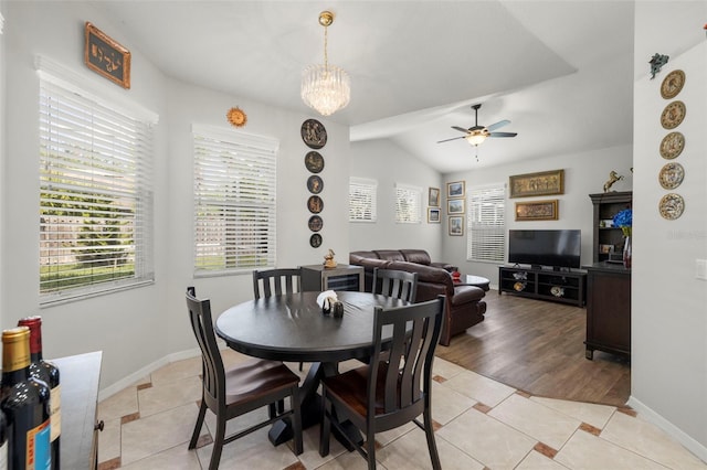 19104 Cellini Pl, Lutz, FL 33558 - dining space featuring ceiling fan, light tile patterned floors, lofted ceiling, and a chandelier