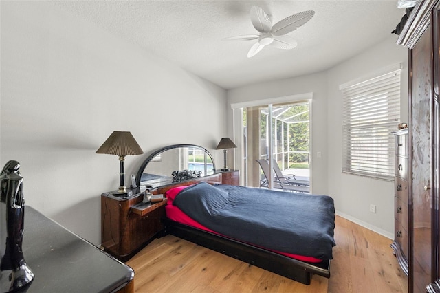 19104 Cellini Pl, Lutz, FL 33558 - bedroom featuring access to exterior, light wood-style flooring, a ceiling fan, and a textured ceiling