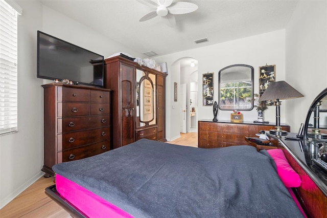 19104 Cellini Pl, Lutz, FL 33558 - bedroom featuring arched walkways, light wood finished floors, and a ceiling fan
