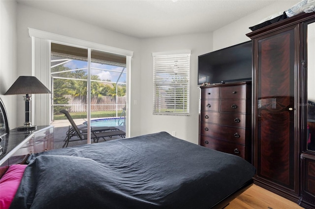 19104 Cellini Pl, Lutz, FL 33558 - bedroom featuring access to outside and wood finished floors