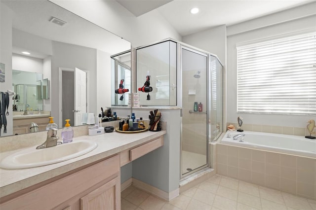 19104 Cellini Pl, Lutz, FL 33558 - full bathroom featuring tile patterned floors, vanity, a stall shower, a bath, and recessed lighting