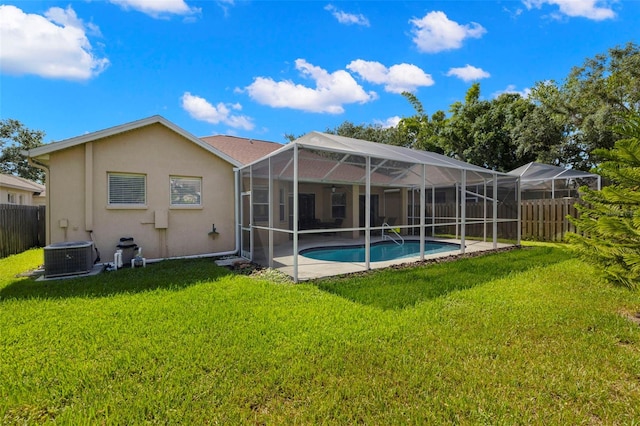 19104 Cellini Pl, Lutz, FL 33558 - back of house featuring stucco siding, a fenced backyard, glass enclosure, and a patio area