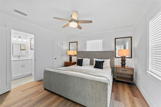 9000 Bay St NE, Saint Petersburg, FL 33702 - bedroom featuring light wood-type flooring, multiple windows, a sink, and ornamental molding