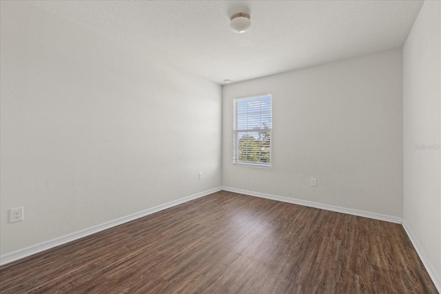 14403 Dunrobin Dr, Wimauma, FL 33598 - empty room featuring dark wood-style floors and baseboards