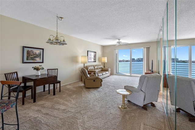 7932 Sailboat Key Blvd S Unit 406, South Pasadena, FL 33707 - carpeted living area with plenty of natural light, a textured ceiling, a chandelier, a water view, and a ceiling fan