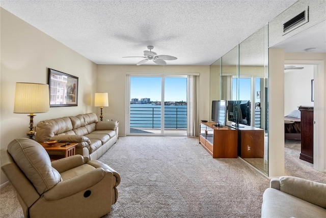 7932 Sailboat Key Blvd S Unit 406, South Pasadena, FL 33707 - carpeted living room with a ceiling fan and a textured ceiling