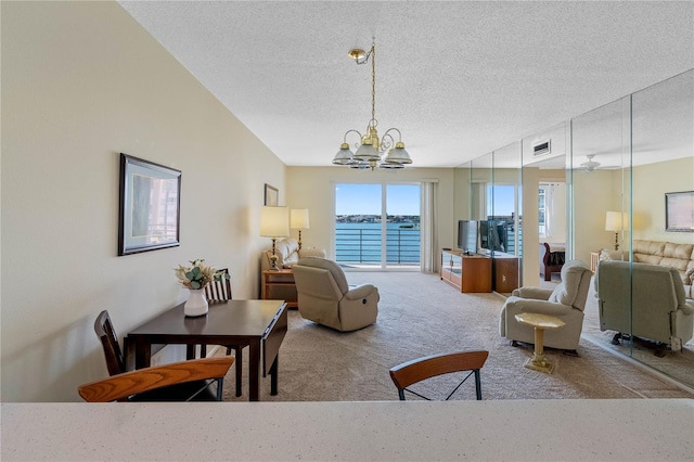 7932 Sailboat Key Blvd S Unit 406, South Pasadena, FL 33707 - living room featuring a chandelier, a textured ceiling, and carpet flooring