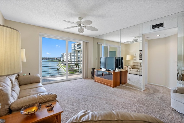 7932 Sailboat Key Blvd S Unit 406, South Pasadena, FL 33707 - living room with ceiling fan, carpet flooring, and a textured ceiling