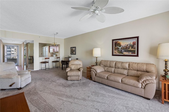 7932 Sailboat Key Blvd S Unit 406, South Pasadena, FL 33707 - carpeted living room with a ceiling fan, a chandelier, and a textured ceiling