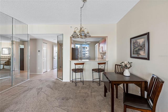 7932 Sailboat Key Blvd S Unit 406, South Pasadena, FL 33707 - dining area featuring a chandelier, light carpet, and a textured ceiling