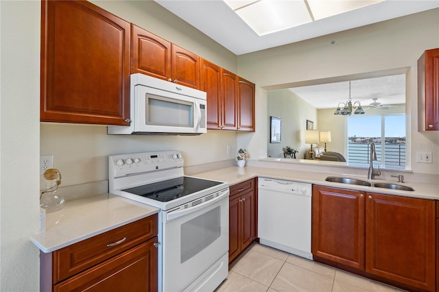 7932 Sailboat Key Blvd S Unit 406, South Pasadena, FL 33707 - kitchen with white appliances, light countertops, light tile patterned flooring, a chandelier, and decorative light fixtures