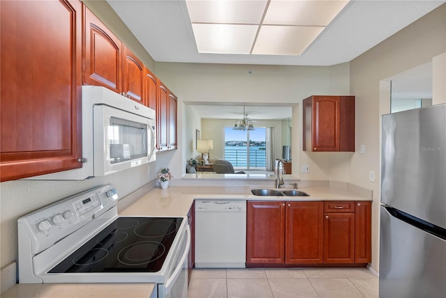 7932 Sailboat Key Blvd S Unit 406, South Pasadena, FL 33707 - kitchen featuring white appliances, light countertops, light tile patterned floors, and a chandelier