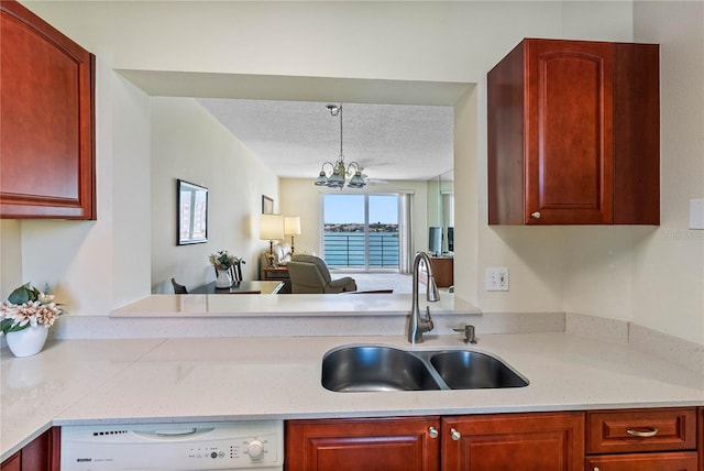 7932 Sailboat Key Blvd S Unit 406, South Pasadena, FL 33707 - kitchen featuring dishwasher, a textured ceiling, a chandelier, open floor plan, and dark brown cabinets