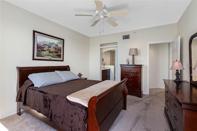 7932 Sailboat Key Blvd S Unit 406, South Pasadena, FL 33707 - bedroom featuring light colored carpet, ceiling fan, a textured ceiling, and ensuite bathroom