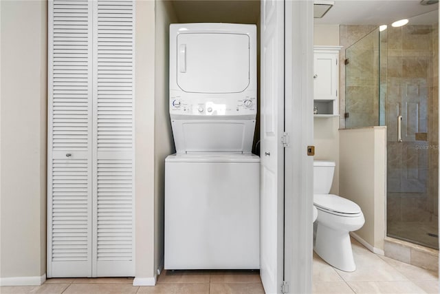 7932 Sailboat Key Blvd S Unit 406, South Pasadena, FL 33707 - full bath with a closet, stacked washer and clothes dryer, a shower stall, and tile patterned floors