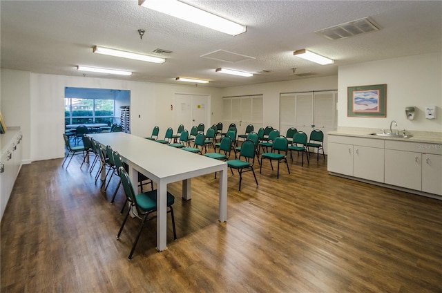 7932 Sailboat Key Blvd S Unit 406, South Pasadena, FL 33707 - dining room featuring dark wood finished floors and a textured ceiling