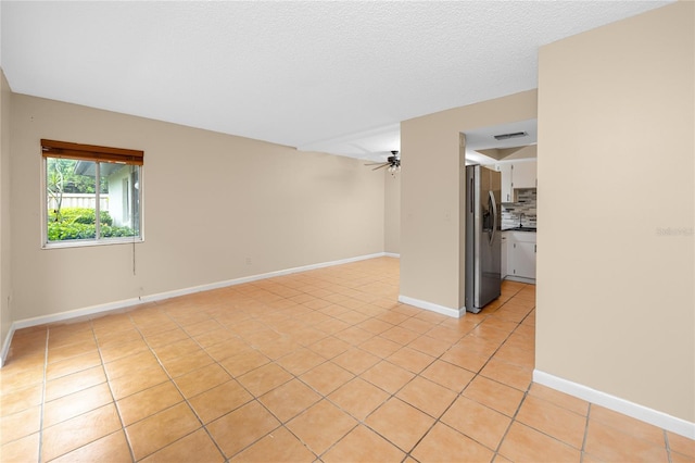 1881 Lichen Ln Unit B, Clearwater, FL 33760 - empty room with ceiling fan, light tile patterned floors, and baseboards