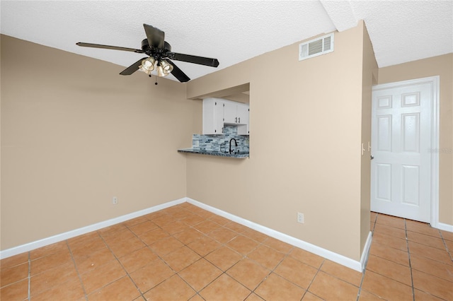 1881 Lichen Ln Unit B, Clearwater, FL 33760 - empty room featuring light tile patterned floors, ceiling fan, a textured ceiling, a sink, and baseboards