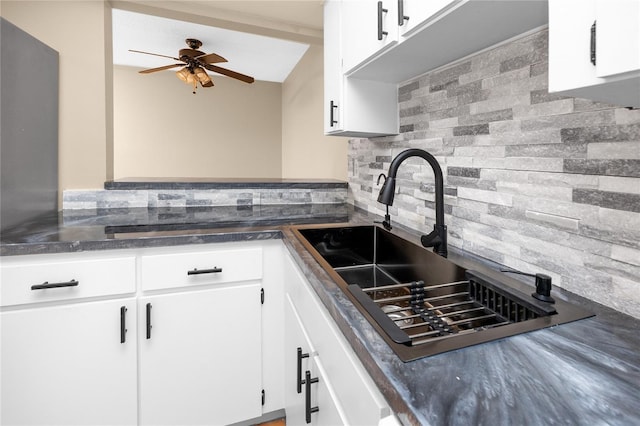 1881 Lichen Ln Unit B, Clearwater, FL 33760 - kitchen featuring backsplash, a sink, dark countertops, white cabinetry, and a ceiling fan