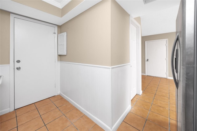 1881 Lichen Ln Unit B, Clearwater, FL 33760 - foyer featuring light tile patterned flooring and a wainscoted wall