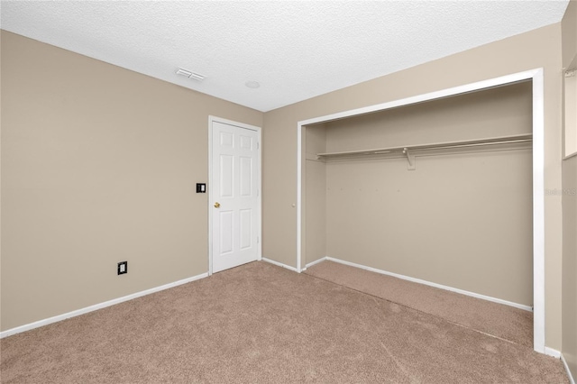 1881 Lichen Ln Unit B, Clearwater, FL 33760 - unfurnished bedroom featuring carpet flooring, baseboards, a closet, and a textured ceiling
