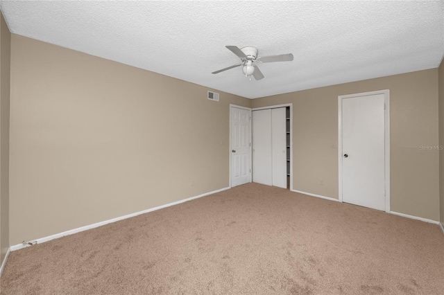1881 Lichen Ln Unit B, Clearwater, FL 33760 - unfurnished bedroom with carpet flooring, baseboards, a textured ceiling, and ceiling fan
