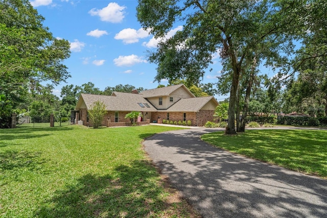 2306 S Valrico Rd, Valrico, FL 33596 - view of front of property featuring curved driveway, a chimney, and brick siding