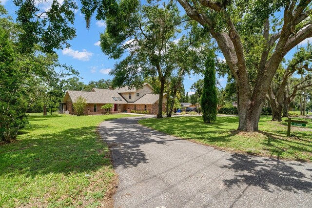 2306 S Valrico Rd, Valrico, FL 33596 - view of front facade featuring a front lawn, brick siding, and driveway