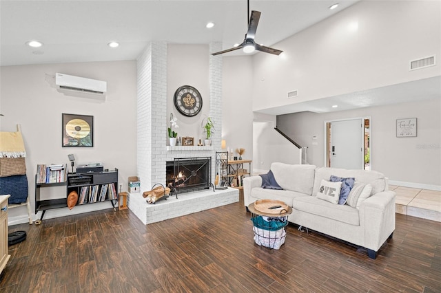 2306 S Valrico Rd, Valrico, FL 33596 - living area featuring a wall mounted AC, high vaulted ceiling, a fireplace, a ceiling fan, and wood finished floors