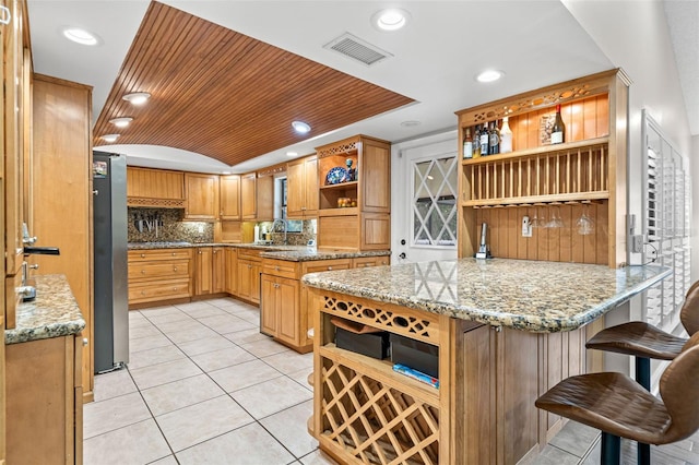 2306 S Valrico Rd, Valrico, FL 33596 - kitchen with open shelves, freestanding refrigerator, decorative backsplash, light tile patterned flooring, and a peninsula