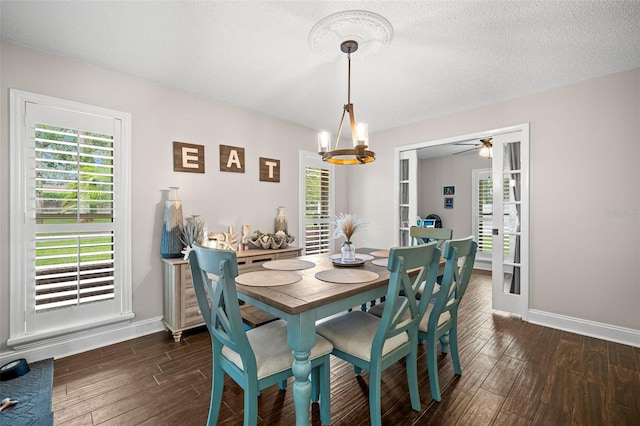 2306 S Valrico Rd, Valrico, FL 33596 - dining room featuring dark wood-style flooring, a chandelier, plenty of natural light, a textured ceiling, and a ceiling fan