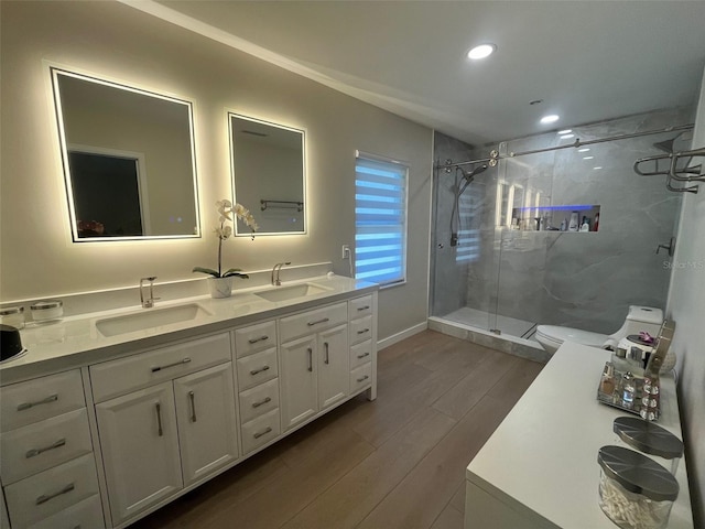 2306 S Valrico Rd, Valrico, FL 33596 - bathroom with wood finished floors, a stall shower, double vanity, and recessed lighting
