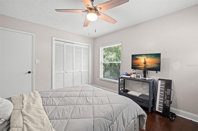 2306 S Valrico Rd, Valrico, FL 33596 - bedroom featuring wood finished floors, a closet, a textured ceiling, and ceiling fan