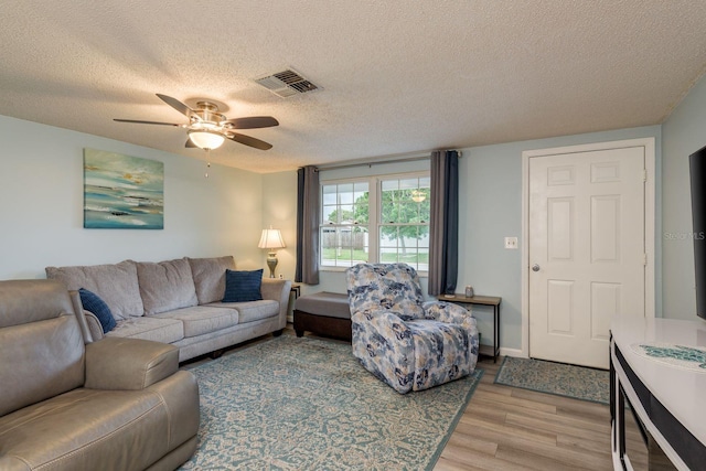 7901 Marlboro Dr, Port Richey, FL 34668 - living area featuring a textured ceiling, light wood-style floors, and ceiling fan