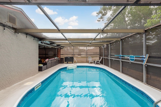 7901 Marlboro Dr, Port Richey, FL 34668 - view of swimming pool featuring a pool, a patio area, glass enclosure, and an outdoor hangout area
