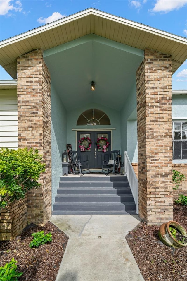 338 7th Ave N, Tierra Verde, FL 33715 - view of exterior entry featuring stucco siding and a porch