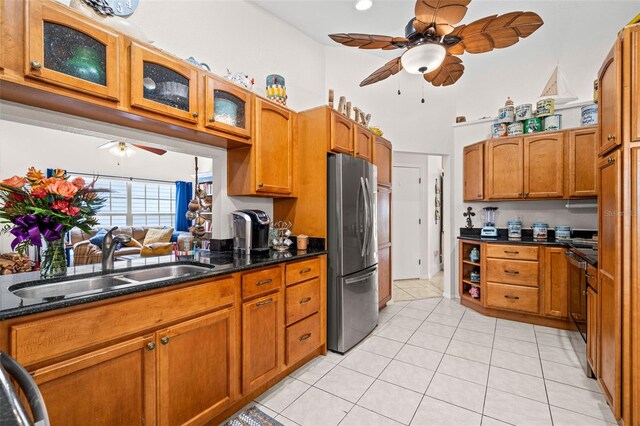 338 7th Ave N, Tierra Verde, FL 33715 - kitchen featuring ceiling fan, freestanding refrigerator, a sink, and brown cabinetry