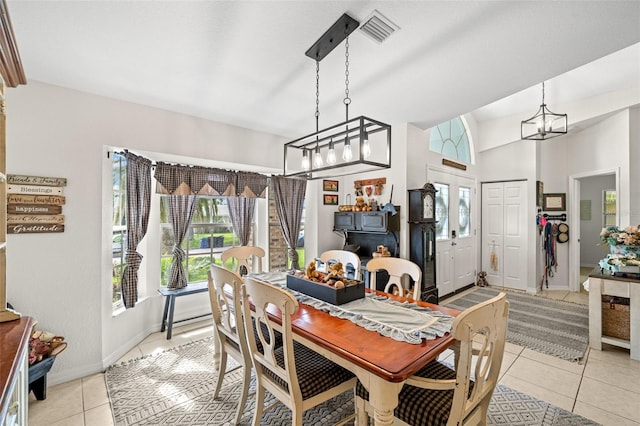 338 7th Ave N, Tierra Verde, FL 33715 - dining space featuring healthy amount of natural light, light tile patterned floors, a chandelier, and baseboards