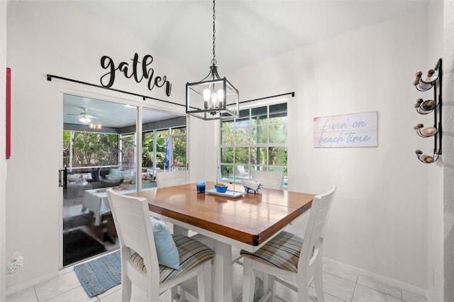 338 7th Ave N, Tierra Verde, FL 33715 - dining space featuring a chandelier, light tile patterned floors, baseboards, and lofted ceiling