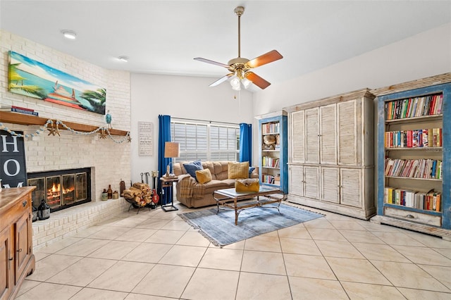 338 7th Ave N, Tierra Verde, FL 33715 - living room with ceiling fan, light tile patterned flooring, a fireplace, and a high ceiling