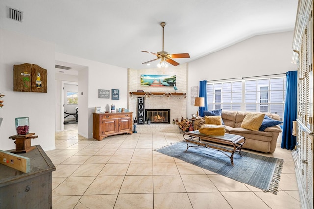 338 7th Ave N, Tierra Verde, FL 33715 - living room featuring ceiling fan, a brick fireplace, light tile patterned flooring, and vaulted ceiling