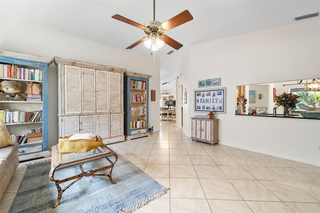 338 7th Ave N, Tierra Verde, FL 33715 - living room featuring ceiling fan, light tile patterned floors, high vaulted ceiling, and baseboards