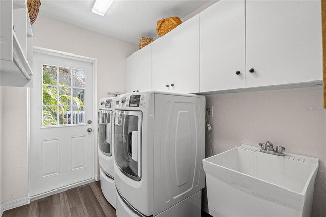 338 7th Ave N, Tierra Verde, FL 33715 - washroom featuring cabinet space, separate washer and dryer, and dark wood-style floors