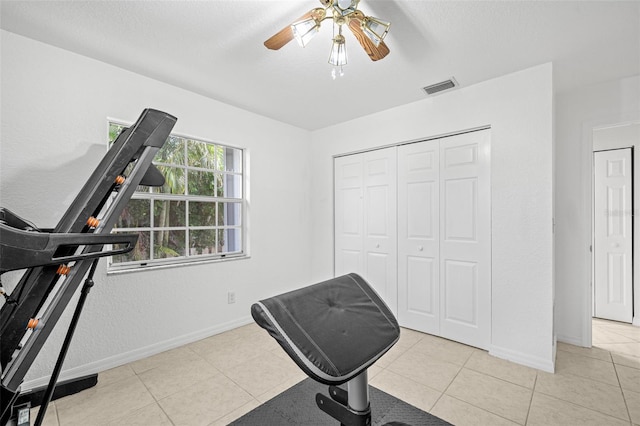 338 7th Ave N, Tierra Verde, FL 33715 - exercise room featuring a ceiling fan, tile patterned flooring, and baseboards
