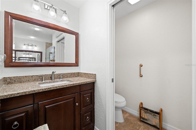 338 7th Ave N, Tierra Verde, FL 33715 - bathroom with toilet, vanity, and baseboards