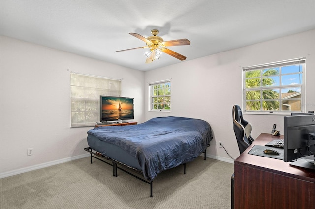 338 7th Ave N, Tierra Verde, FL 33715 - bedroom with baseboards, a desk, light colored carpet, and a ceiling fan