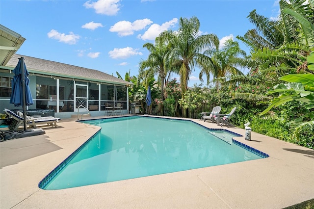338 7th Ave N, Tierra Verde, FL 33715 - swimming pool with a sunroom and a patio area