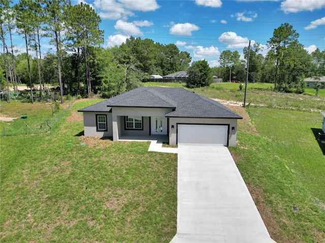 2705 W Royal Palm Dr, Citrus Springs, FL 34434 - view of front facade featuring stucco siding, a garage, driveway, and a front lawn