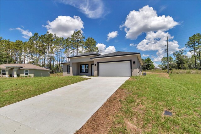 2705 W Royal Palm Dr, Citrus Springs, FL 34434 - view of front of house with stucco siding, an attached garage, driveway, and a front lawn