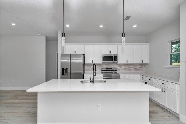 2705 W Royal Palm Dr, Citrus Springs, FL 34434 - kitchen featuring stainless steel appliances, light wood-style flooring, tasteful backsplash, white cabinets, and recessed lighting